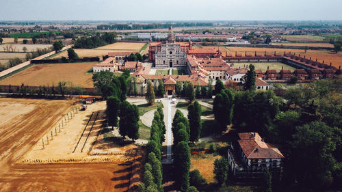 High angle view of buildings and trees in city