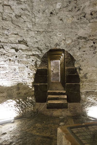 Old stone wall by staircase