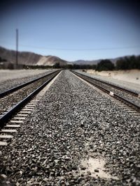 Surface level of railroad track against clear sky