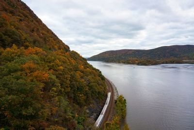 Scenic view of river amidst mountains against sky