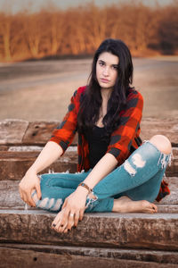 Portrait of young woman sitting outdoors