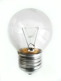 Close-up of light bulb against white background