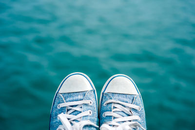 Close-up of shoe by sea