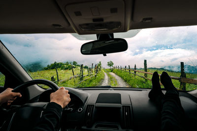 Man driving car on misty mountain road. people traveling by  car. 