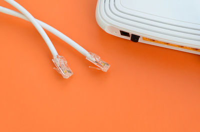 Computer cables and router on table