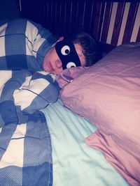 Portrait of boy sleeping on bed at home