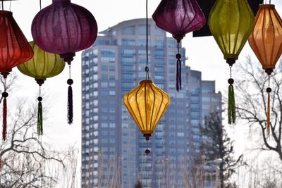 Low angle view of lanterns hanging against sky