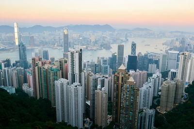 High angle view of modern buildings in city during sunset