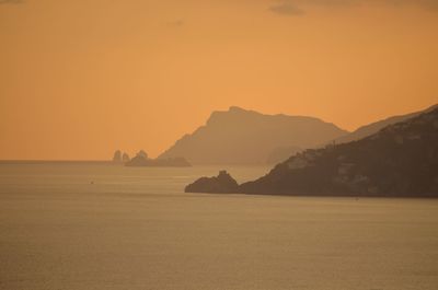 Scenic view of sea against orange sky