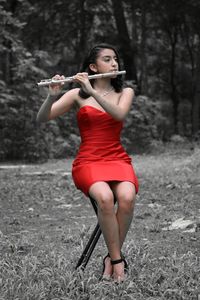 Midsection of woman holding red umbrella