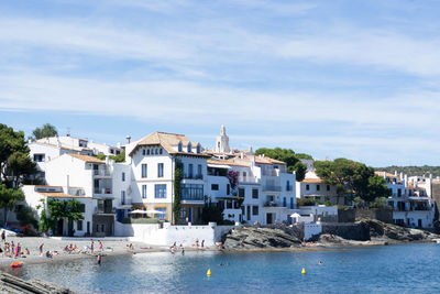 Houses by sea against sky at cadaques