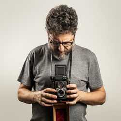 Man holding camera against white background