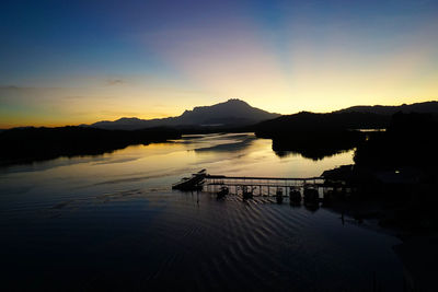 Scenic view of calm beach at sunset