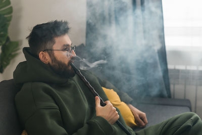 Young man smoking cigarette