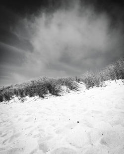 Scenic view of snow covered field against sky