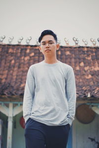 Portrait of young man standing outdoors