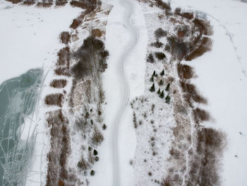 High angle view of footprints on snow covered field