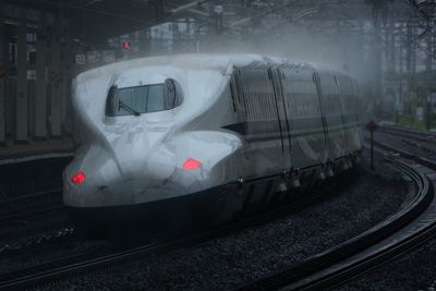 Tokaido shinkansen n700a passing through maibara station at rainy day