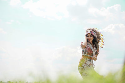 Portrait of a smiling young woman standing outdoors