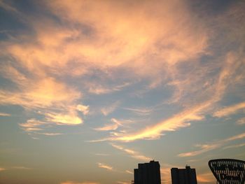 Low angle view of cloudy sky at sunset