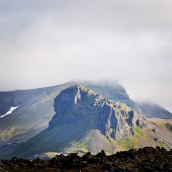 Scenic view of volcanic mountain against sky