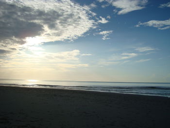 Scenic view of beach against sky during sunset