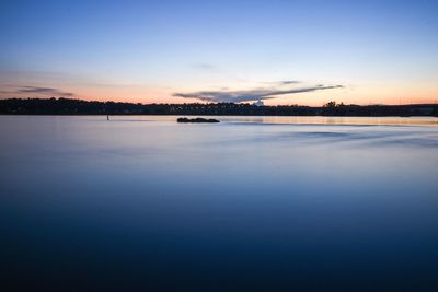 Scenic view of calm lake at sunset