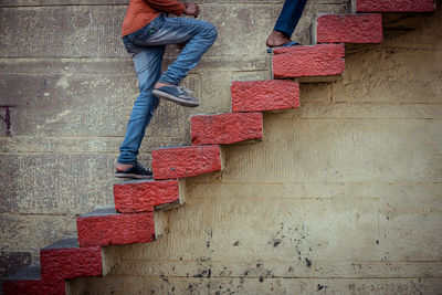 Low section of person against red wall