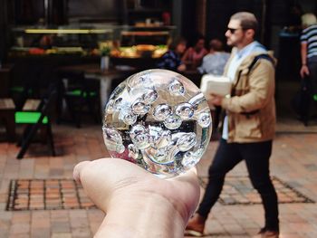 Close-up of human hand holding crystal ball