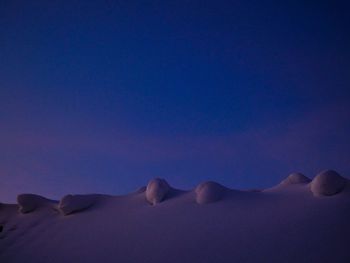 Scenic view of desert against clear blue sky