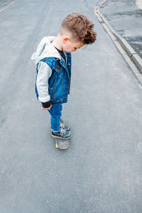 High angle view of boy standing on road