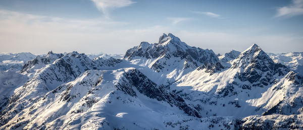 Scenic view of snowcapped mountains against sky