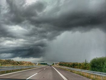 Road passing through storm clouds