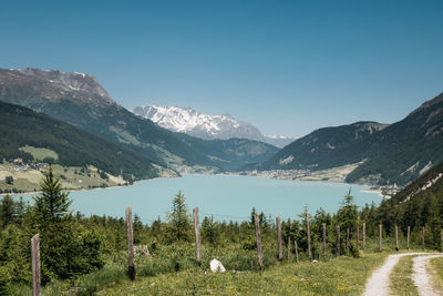 Scenic view of lake and mountains against clear sky