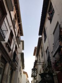 Low angle view of buildings in town against sky