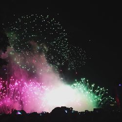 Low angle view of firework display at night