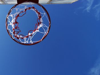 Low angle view of basketball hoop against blue sky