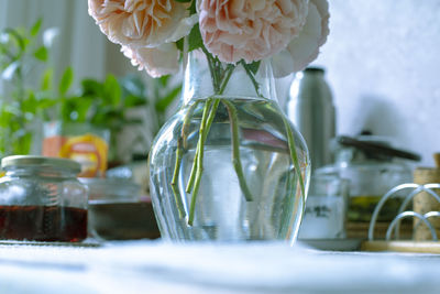 Close-up of flower vase on glass table