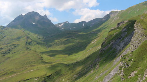 Scenic view of valley and mountains against sky