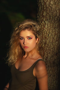 Portrait of a beautiful young woman with tree