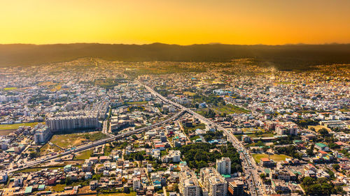 Aerial view of townscape against sky during sunset
