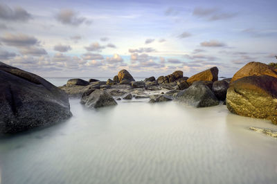 Panoramic shot of rocks in sea against sky