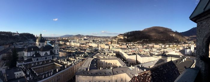 View of cityscape against blue sky