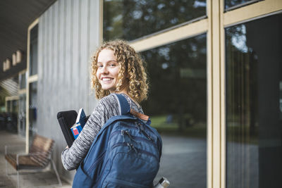 Portrait of smiling woman standing outdoors