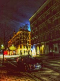Illuminated building by street at night