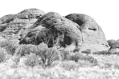 Rock formations on landscape against sky