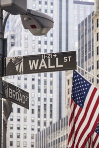 Low angle view of sign against buildings in city