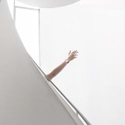 Low angle view of woman standing against wall