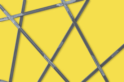 Low angle view of yellow metal fence