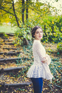 Beautiful girl in a white lace blouse in an autumn park
